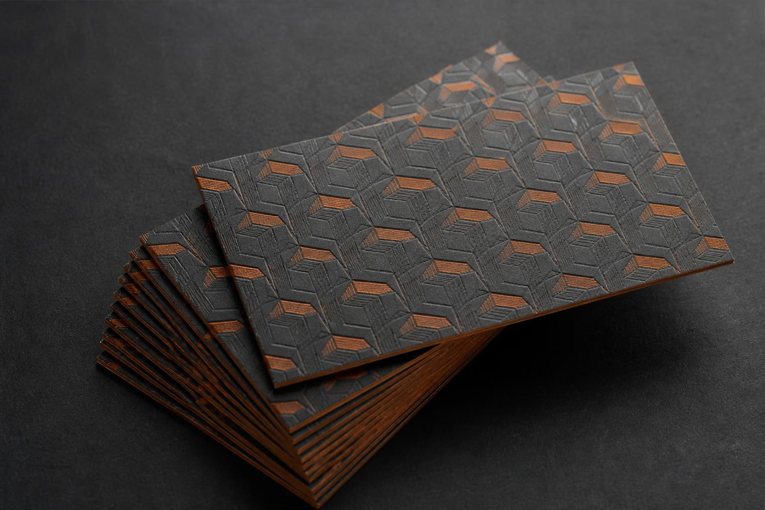 Stack of premium business cards with an embossed pattern